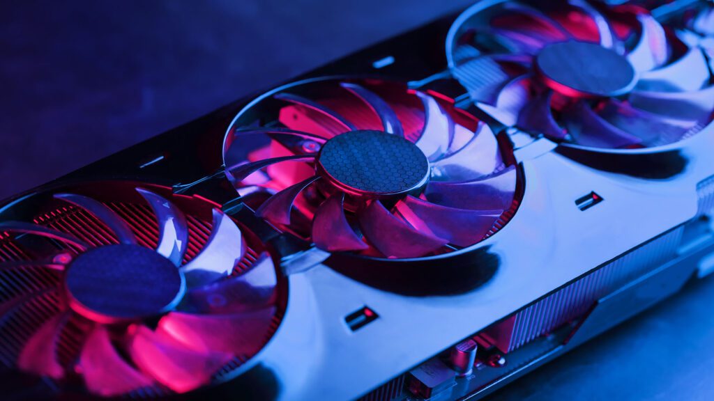 Close-up of high-performance graphics card with three illuminated cooling fans and visible heat sink